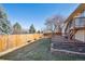 Well-maintained yard with a spacious deck and a privacy fence at 7477 Holland Ct, Arvada, CO 80005