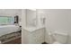 Well-lit bathroom showcasing vanity with marble countertop and a glimpse into a bedroom with large window at 705 S Alton Way # 4D, Denver, CO 80247