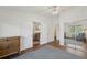 Bright bedroom with an open doorway, ceiling fan, and modern furniture showcasing the home's layout and design at 705 S Alton Way # 4D, Denver, CO 80247