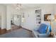 Comfortable bedroom featuring a wall bed, built-in shelving, plush chair, mirrored closet, and ceiling fan at 705 S Alton Way # 4D, Denver, CO 80247