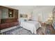 Bright bedroom with white walls, built-in wood shelving, decorative carpet, and a comfortable bed at 705 S Alton Way # 4D, Denver, CO 80247