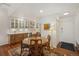 Charming kitchen with wood cabinets, farmhouse sink, recessed lighting, and adjacent dining area at 705 S Alton Way # 4D, Denver, CO 80247