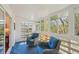 Bright sunroom with blue wicker seating, tile floor and an abundance of light at 705 S Alton Way # 4D, Denver, CO 80247