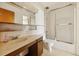 Bathroom features a large mirror and glass shower door at 655 S Alton Way # 8D, Denver, CO 80247