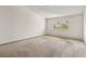 Bright bedroom featuring large window with outside views, and neutral carpet for comfort at 655 S Alton Way # 8D, Denver, CO 80247