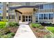 Inviting entrance with landscaped garden and a clear view of the building's front doors at 655 S Alton Way # 8D, Denver, CO 80247