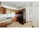 Traditional kitchen featuring wood cabinets, stainless steel sink, and black refrigerator at 655 S Alton Way # 8D, Denver, CO 80247