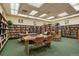 Bright library featuring rows of bookshelves, tables, and chairs for reading or studying at 655 S Alton Way # 8D, Denver, CO 80247