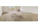 Spacious carpeted living room featuring a sliding glass door to the balcony at 655 S Alton Way # 8D, Denver, CO 80247