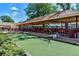Outdoor seating and cooking area features covered picnic tables and a bocce ball court at 655 S Alton Way # 8D, Denver, CO 80247