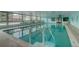 Indoor pool with abundant natural light and clear blue water, adjacent to a lounging area at 655 S Alton Way # 8D, Denver, CO 80247
