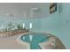 Indoor hot tub/spa area with relaxing blue walls, unique décor, and lush greenery at 655 S Alton Way # 8D, Denver, CO 80247