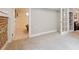 Partially finished basement with painted walls, carpet, and doorway to unfinished room at 3044 W 40Th Ave, Denver, CO 80211
