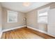 Cozy bedroom with hardwood floors, natural light from two windows, and simple elegant decor with new white trim at 3044 W 40Th Ave, Denver, CO 80211
