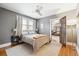 Comfortable bedroom with gray walls, ceiling fan, and natural light, and glass paneled french doors at 3044 W 40Th Ave, Denver, CO 80211