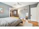 Bright bedroom with hardwood floors, gray walls, a ceiling fan, and natural light in a neutrally decorated space at 3044 W 40Th Ave, Denver, CO 80211