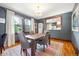 Dining room with hardwood floors, large windows, and modern chandelier at 3044 W 40Th Ave, Denver, CO 80211