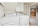 Bright laundry room with washer and dryer, white cabinets, and neutral decor and is brightly lit at 3044 W 40Th Ave, Denver, CO 80211