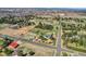 Vast aerial view of the property featuring the home, solar panels, landscaping, and neighborhood at 16816 E Costilla Ave, Foxfield, CO 80016