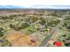 Scenic aerial view of the property, highlighting its location, landscaping, and proximity to the city at 16816 E Costilla Ave, Foxfield, CO 80016