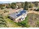 Picturesque aerial view of the home, showcasing the patio, solar panels and the surrounding landscape at 16816 E Costilla Ave, Foxfield, CO 80016