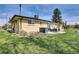 Spacious backyard with patio seating, green grass, and well-maintained landscaping, perfect for outdoor activities at 16816 E Costilla Ave, Foxfield, CO 80016
