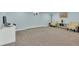 Finished basement with carpet, neutral walls, and a workspace with a laptop at 16816 E Costilla Ave, Foxfield, CO 80016