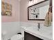 Well-lit bathroom with a stylish vanity, classic fixtures, neutral colors, and artistic wall décor at 16816 E Costilla Ave, Foxfield, CO 80016