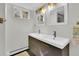 Bathroom with double vanity featuring dark wood cabinets, white countertops, and framed mirrors at 16816 E Costilla Ave, Foxfield, CO 80016