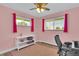 Bright bedroom with pink walls, hardwood flooring, and large windows for plenty of light at 16816 E Costilla Ave, Foxfield, CO 80016