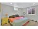 Cozy bedroom with neutral walls, carpet flooring, and a large window for natural light at 16816 E Costilla Ave, Foxfield, CO 80016