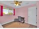 Bedroom with pink walls, wood floors, and a chair near the keyboard at 16816 E Costilla Ave, Foxfield, CO 80016