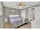 Cozy bedroom featuring gray walls, wood floor, ceiling fan, and double door closet at 16816 E Costilla Ave, Foxfield, CO 80016
