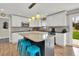 Updated kitchen featuring white cabinets, granite countertops, stainless steel appliances, and blue island seating at 16816 E Costilla Ave, Foxfield, CO 80016