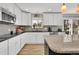 Updated kitchen boasting granite countertops, tile backsplash, and stainless steel appliances at 16816 E Costilla Ave, Foxfield, CO 80016