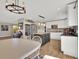 Spacious kitchen featuring white cabinets, wood floors, stainless steel appliances, and an oversized center island at 16816 E Costilla Ave, Foxfield, CO 80016