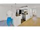 Bright kitchen features stainless steel appliances, white cabinets, and a breakfast bar with two stools at 16816 E Costilla Ave, Foxfield, CO 80016
