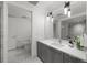 Modern bathroom with gray cabinets, white countertops, and sleek fixtures at 1750 Wewatta St # 1227, Denver, CO 80202