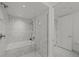 Bathroom showcases a sleek bathtub, with a shower featuring marble tile surround at 1750 Wewatta St # 1227, Denver, CO 80202
