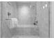 Modern bathroom featuring marble tiling, glass shower enclosure, and sleek fixtures at 1750 Wewatta St # 1227, Denver, CO 80202