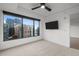 Bedroom with large window offering city views and a ceiling fan for added comfort at 1750 Wewatta St # 1227, Denver, CO 80202
