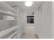 Bright, organized walk-in closet features custom shelving and ample storage space at 1750 Wewatta St # 1227, Denver, CO 80202