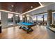 Bright game room with billiards table, foosball, ample lighting and views of the city at 1750 Wewatta St # 1227, Denver, CO 80202