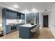 Modern kitchen with blue cabinets, stainless appliances, white countertop, and a breakfast bar at 1750 Wewatta St # 1227, Denver, CO 80202