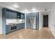 Kitchen with custom blue cabinets, modern appliances, and ample counter space at 1750 Wewatta St # 1227, Denver, CO 80202