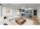 Open-concept living room and modern kitchen features a large sofa, hardwood floors and stainless steel appliances at 1750 Wewatta St # 1227, Denver, CO 80202
