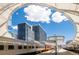 Modern train station and building framed in a modern architectural element on a clear day at 1750 Wewatta St # 1227, Denver, CO 80202