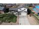Two-story home with driveway and basketball hoop, surrounded by a lush lawn and mature trees at 12173 W 68Th Ave, Arvada, CO 80004