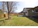 Lush backyard with mature trees and a covered patio area at 12173 W 68Th Ave, Arvada, CO 80004
