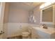 Charming bathroom featuring white wainscoting and a modern vanity sink at 12173 W 68Th Ave, Arvada, CO 80004